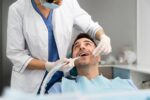a dentist is doing dental implant treatment to a patient