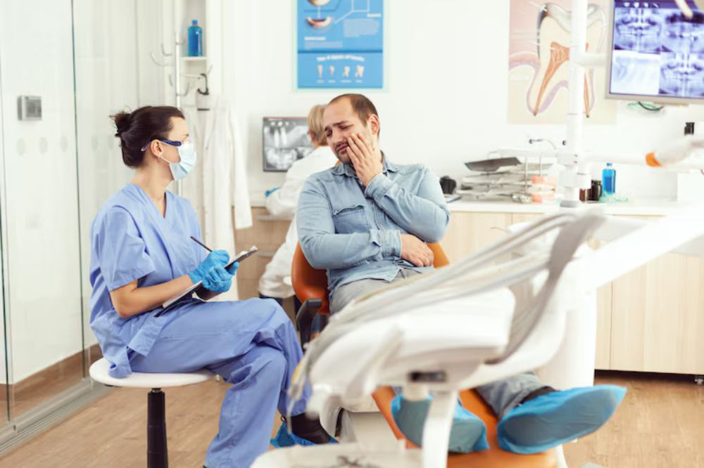 Medical nurse examining patient paing writing dental problem clipboard while sitting dental hospital